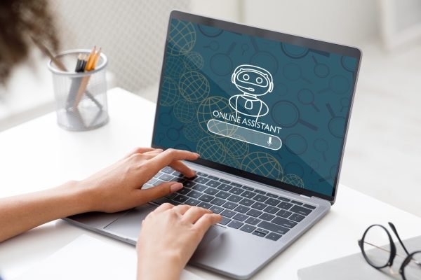 Cropped woman entrepreneur using online assistant on laptop at office